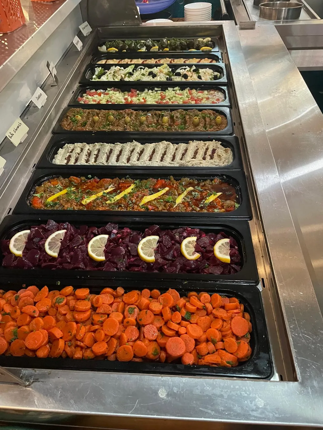 The Marrakesh DC buffet line filled with mezze — dolmas, salads, baba ghanoush, roasted vegetables, beets, and spiced carrots
