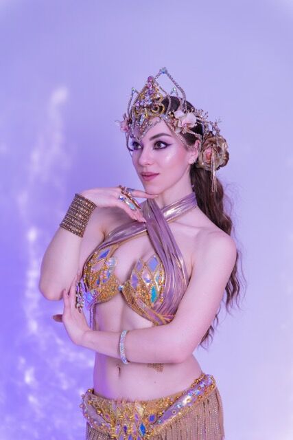 Elizabeth Khard in a jeweled crown and gold costume