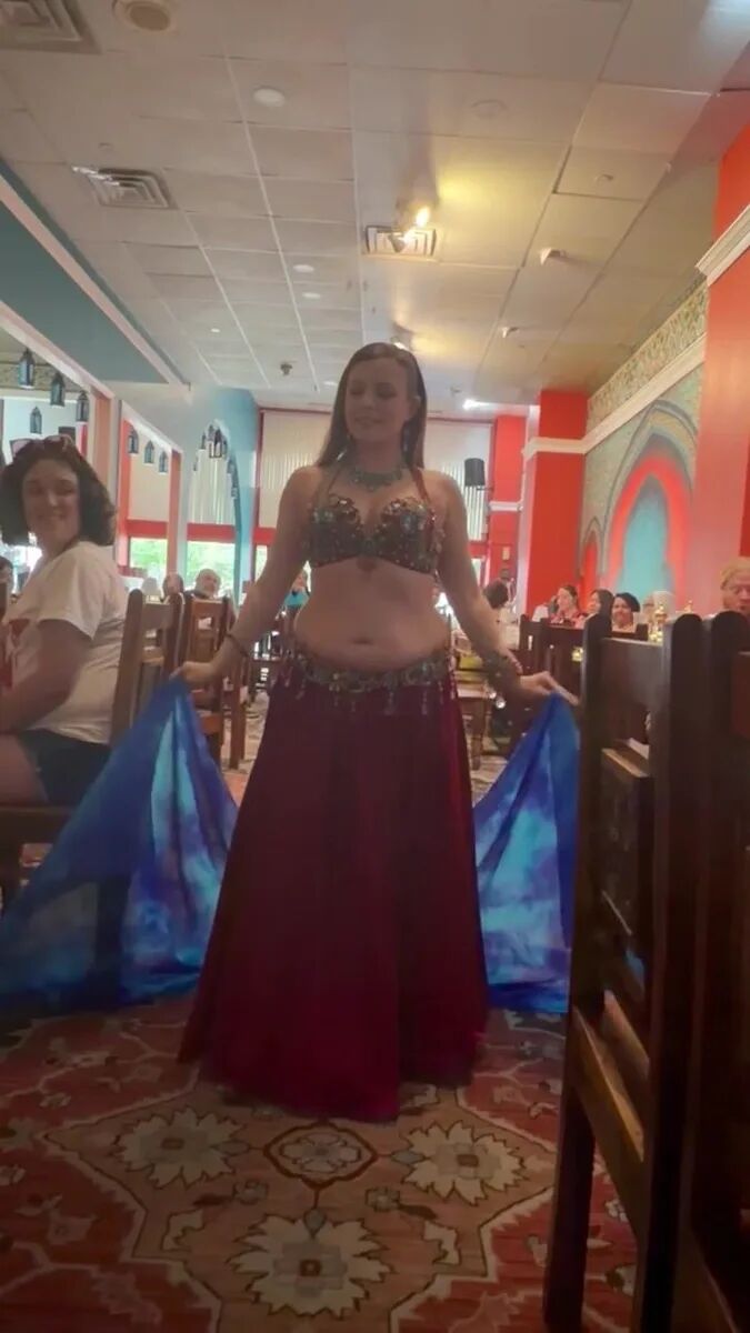 Dancer performing with a flowing blue silk veil at the July Hafla