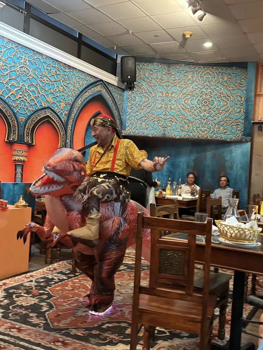 Dancer mid-performance in front of the arched alcove at the inaugural Hafla