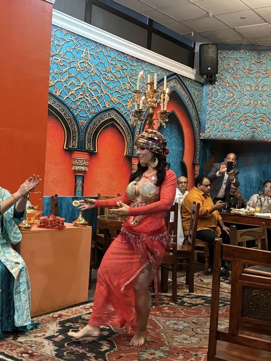Dancer balancing a candelabra while performing at the inaugural Hafla