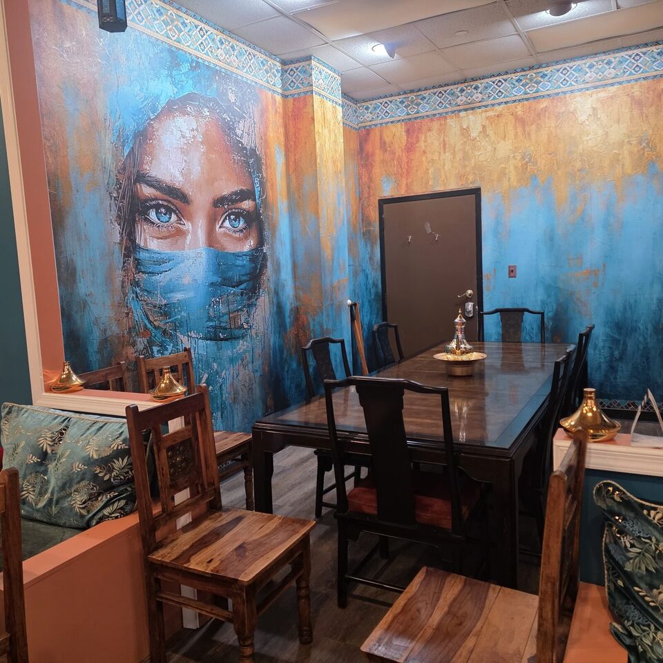 Private dining room at Marrakesh DC with a painted mural of a veiled woman